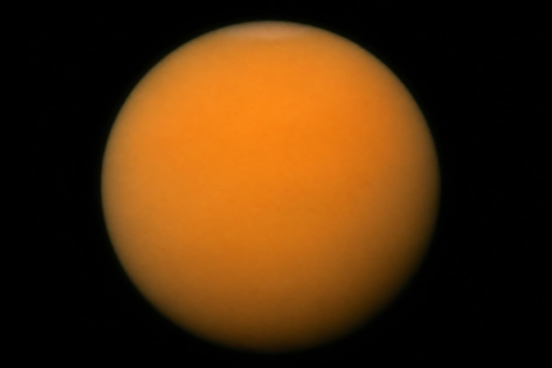 Cassini image of Saturn's moon Titan as a full orange haze globe
