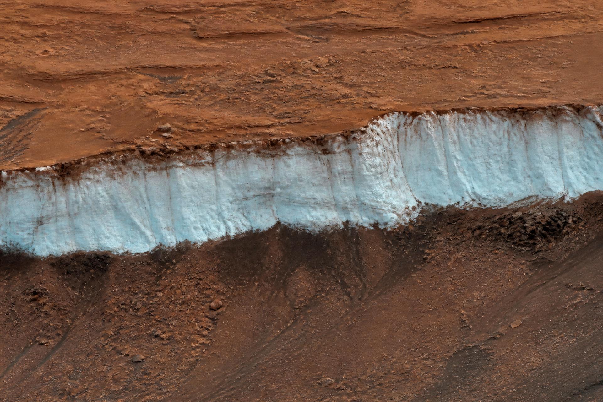 Exposed water ice scarp cutting through Martian regolith